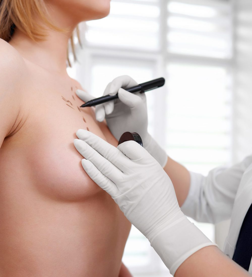 Cropped shot of a young woman visiting doctor preparing for breast augmentation surgery beauty health medicine professionalism surgeon preparation concept.